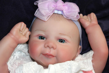 A baby doll resting on a bed, creating a cozy and playful scene.